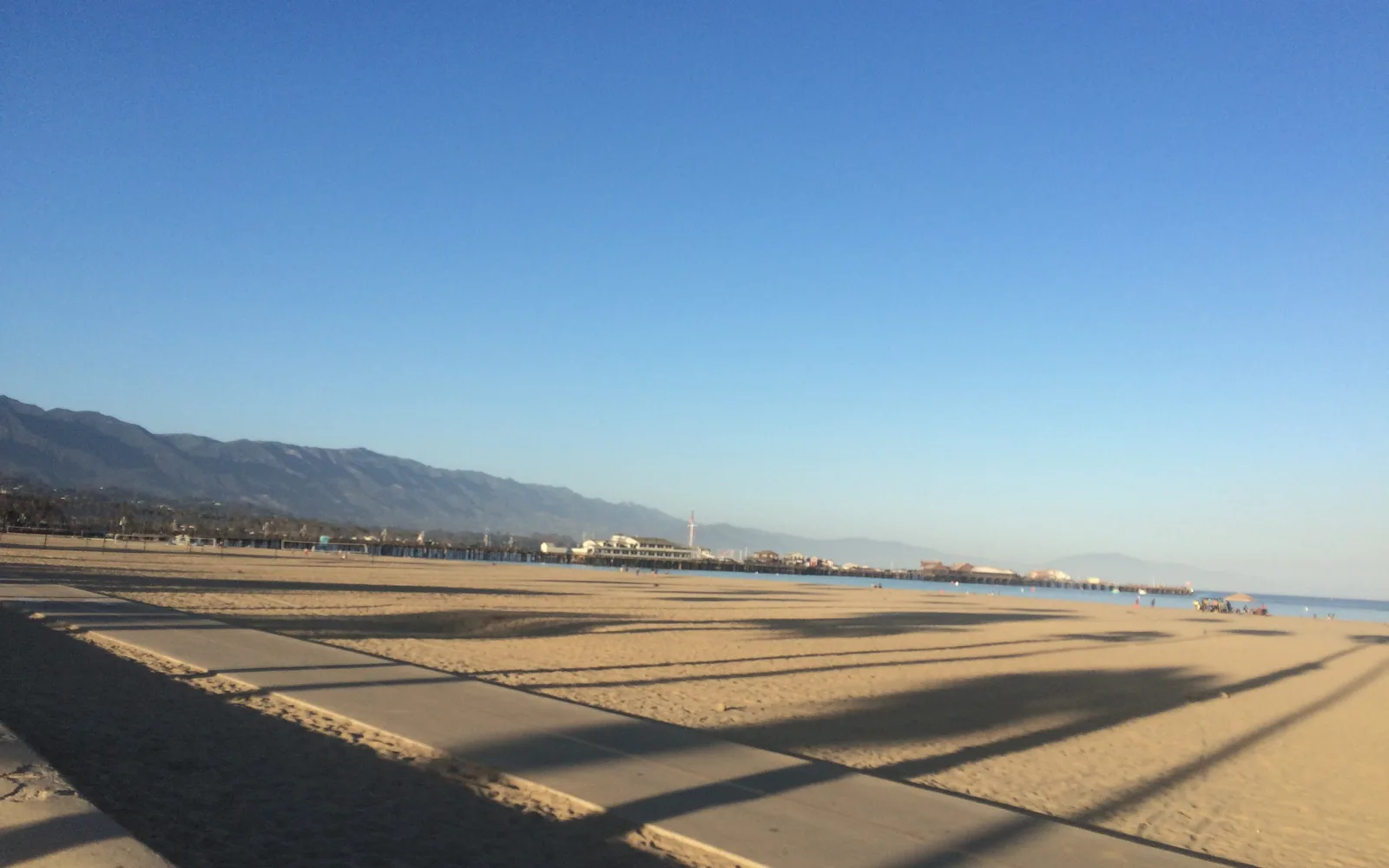 A boardwalk view along the waterfront at Stearns Wharf, with railings and ocean views typical of Santa Barbara's coastal attractions